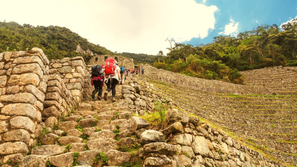 Close-up of Inca architecture at Wiñay Wayna with stone walls and water channels.