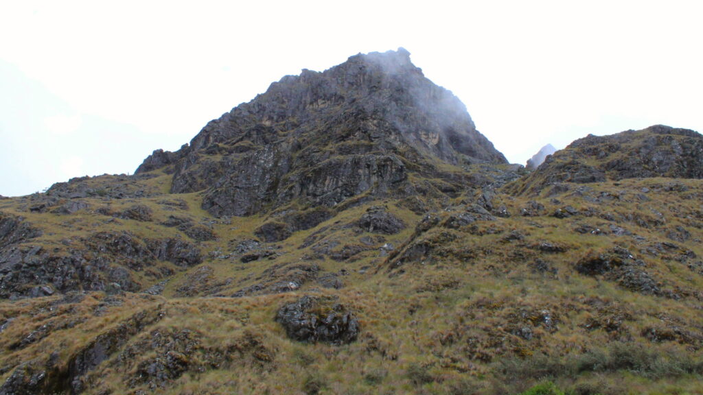 Scenic landscape of Warmiwañusca Pass with towering peaks and verdant valleys on the Inca Trail