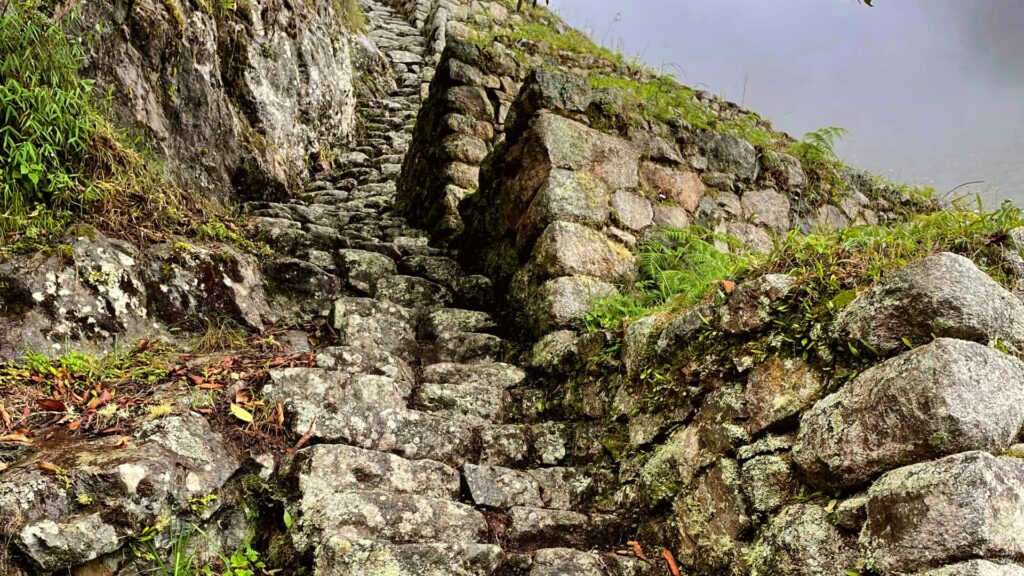 Massive Inca stone blocks perfectly fitted on a mountain slope at Wiñay Wayna.