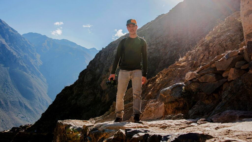 A group of tourists exploring the stone terraces of Ollantaytambo