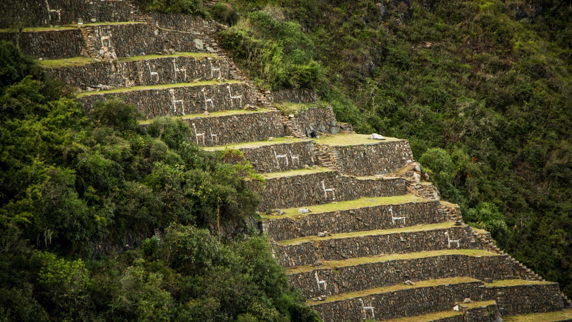 A breathtaking view of the ancient Inca ruins of Choquequirao, nestled in the Andean mountains.