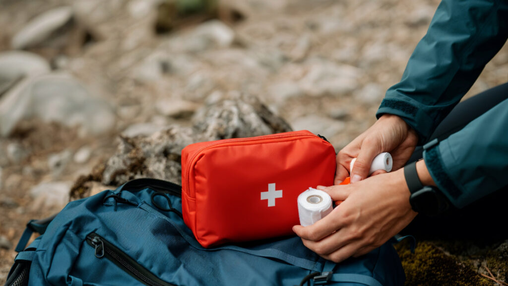 Red trekking first-aid kit with essential medical supplies, emphasizing safety and how to prevent altitude sickness complications on tours - Authentic Incan Adventures
